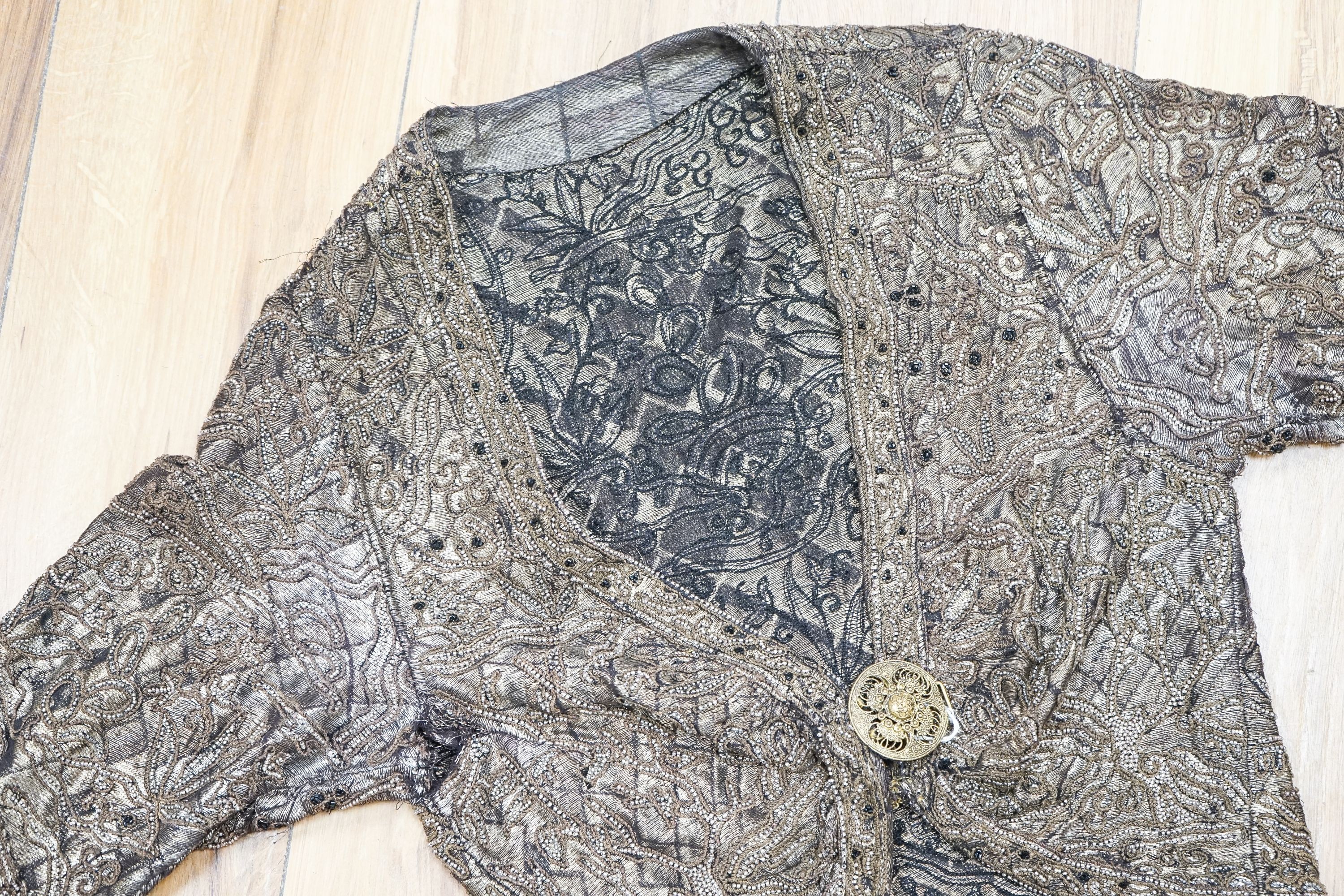 A 1920'3-30's evening bolero jacket in gold lame with silver beading and brown embroidery